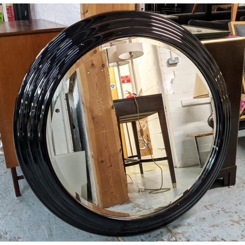 452 - CIRCULAR MIRROR, Karl Springer style, 110cm diam with a ribbed lacquered black frame.