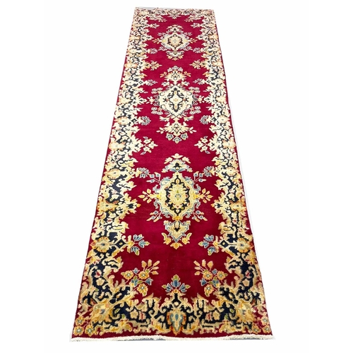 107 - PERSIAN KIRMAN RUNNER, 290cm x 75cm.