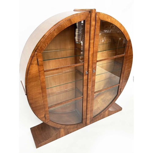 113 - ART DECO DISPLAY CASE, figured walnut of circular form with two half round glazed doors enclosing sh... 