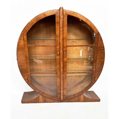 113 - ART DECO DISPLAY CASE, figured walnut of circular form with two half round glazed doors enclosing sh... 