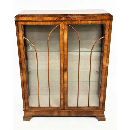 120 - ART DECO DISPLAY CASE, figured walnut with two arched glazed panelled doors enclosing glass shelves,... 