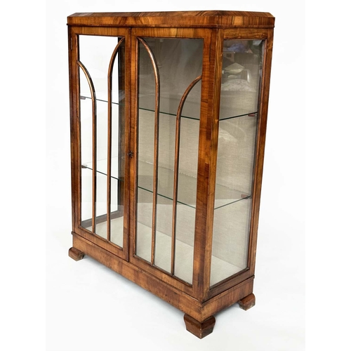 120 - ART DECO DISPLAY CASE, figured walnut with two arched glazed panelled doors enclosing glass shelves,... 