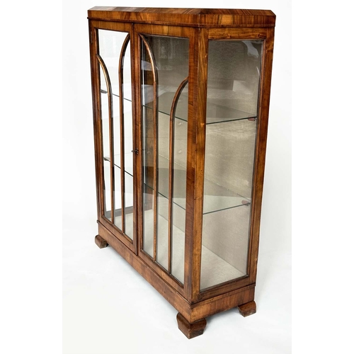 120 - ART DECO DISPLAY CASE, figured walnut with two arched glazed panelled doors enclosing glass shelves,... 