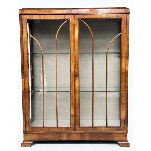 120 - ART DECO DISPLAY CASE, figured walnut with two arched glazed panelled doors enclosing glass shelves,... 