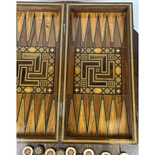 20 - FOLDING CHESSBOARD AND BACKGAMMON BOX, Islamic burr walnut boxwood and kingwood marquetry with mothe... 