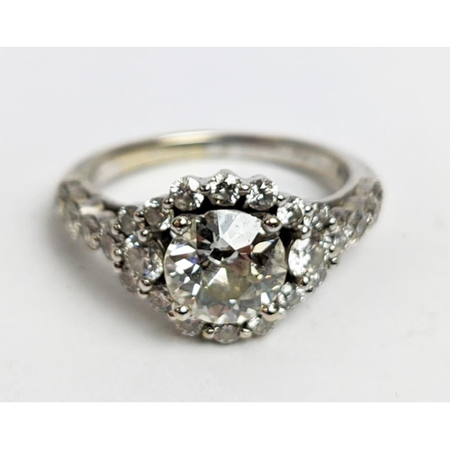 1 - A WHITE METAL DIAMOND SET DRESS RING, probably 18ct white gold, the large round brilliant cut centra... 