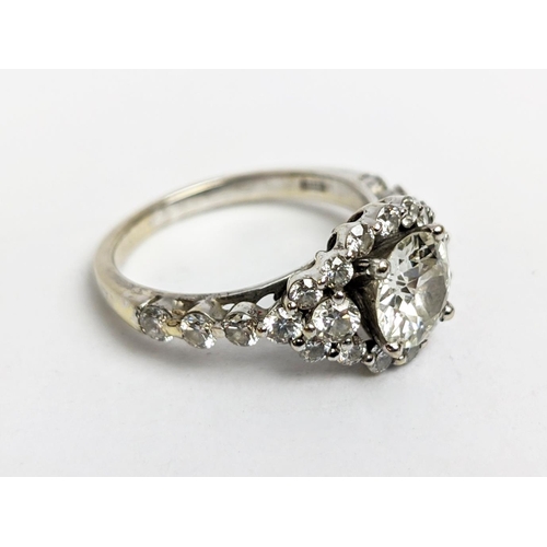 1 - A WHITE METAL DIAMOND SET DRESS RING, probably 18ct white gold, the large round brilliant cut centra... 