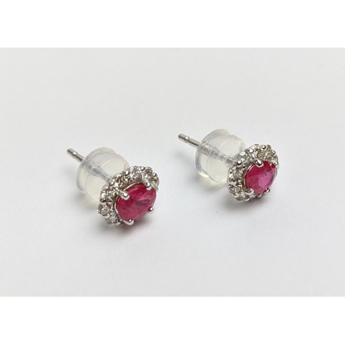 37 - A PAIR OF 18CT WHITE GOLD RUBY AND DIAMOND STUD EARRINGS, each with a single faceted ruby of approxi... 