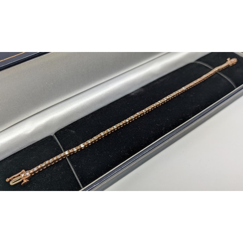 38 - A 10CT ROSE GOLD AND DIAMOND SET BRACELET, set with alternating baguette and round brilliant cut dia... 