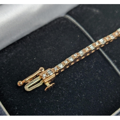 38 - A 10CT ROSE GOLD AND DIAMOND SET BRACELET, set with alternating baguette and round brilliant cut dia... 