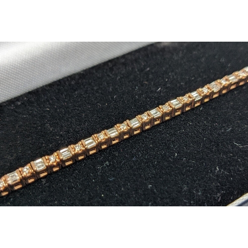 38 - A 10CT ROSE GOLD AND DIAMOND SET BRACELET, set with alternating baguette and round brilliant cut dia... 