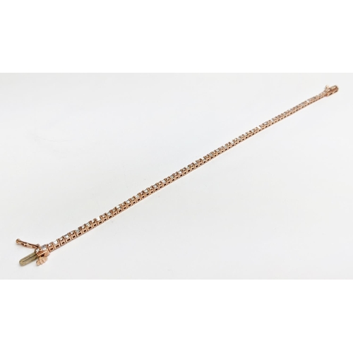 38 - A 10CT ROSE GOLD AND DIAMOND SET BRACELET, set with alternating baguette and round brilliant cut dia... 