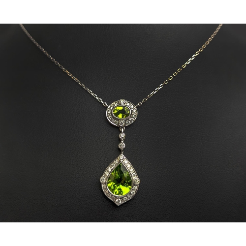 40 - AN 18CT WHITE GOLD PERIDOT AND DIAMOND SET PENDANT NECKLACE, the pear shaped drop pendant surrounded... 