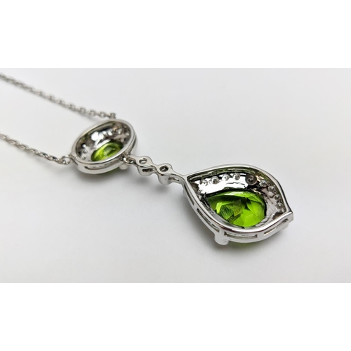 40 - AN 18CT WHITE GOLD PERIDOT AND DIAMOND SET PENDANT NECKLACE, the pear shaped drop pendant surrounded... 