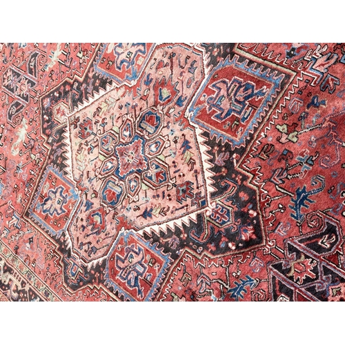 107 - PERSIAN HERIZ CARPET, 340cm x 245cm.