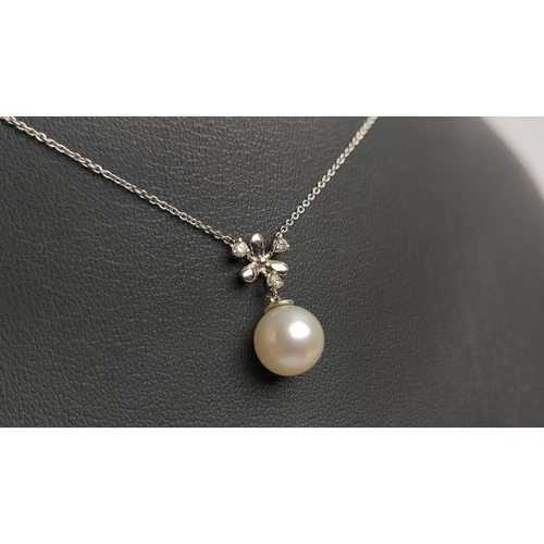 19 - A 9CT WHITE GOLD CULTURED PEARL AND DIAMOND SNOWFLAKE PENDANT NECKLACE, fitted on a fine link chain,... 