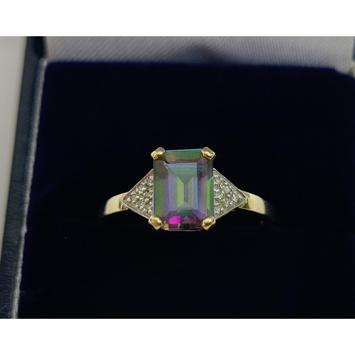 24 - A 9CT GOLD MYSTIC TOPAZ DRESS RING, the emerald cut stone claw set with a diamond encrusted shoulder... 