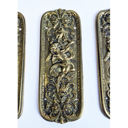 48 - SET OF FOUR BRASS DOOR FINGER PLATES, Art Nouveau style, cast, each depicting a cherub amongst scrol... 