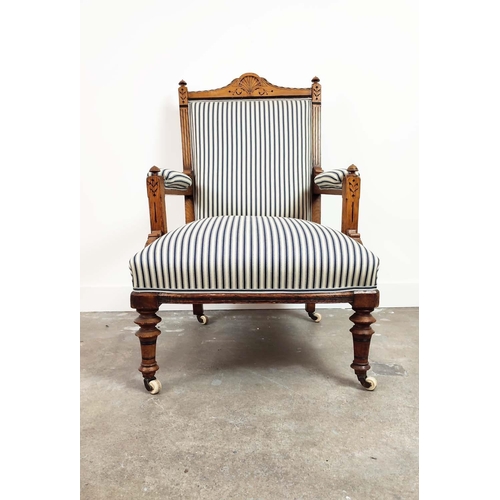 238 - AESTHETIC ARMCHAIR, Victorian oak and ebonised, circa 1870, in blue and white ticking on ceramic cas... 