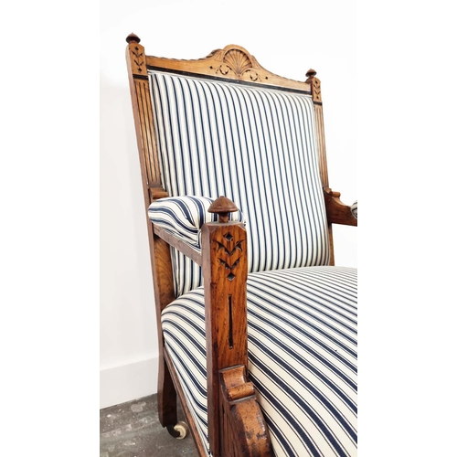 238 - AESTHETIC ARMCHAIR, Victorian oak and ebonised, circa 1870, in blue and white ticking on ceramic cas... 