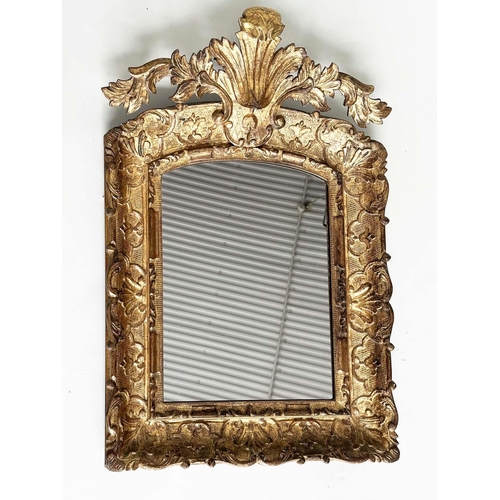 251 - WALL MIRROR, early 19th century Italian carved giltwood grotto style arched with foliate crest, 76cm... 