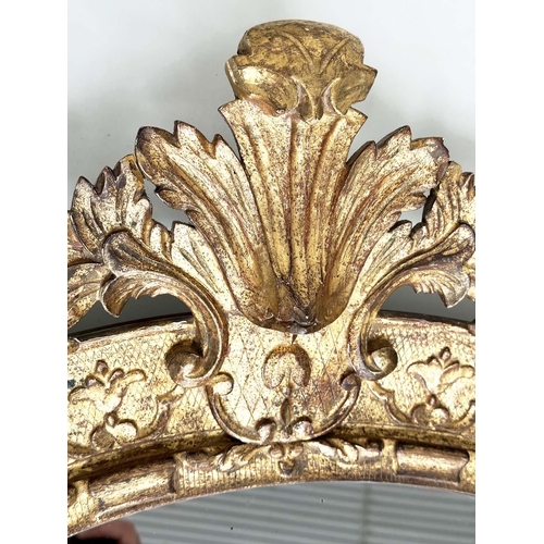 251 - WALL MIRROR, early 19th century Italian carved giltwood grotto style arched with foliate crest, 76cm... 