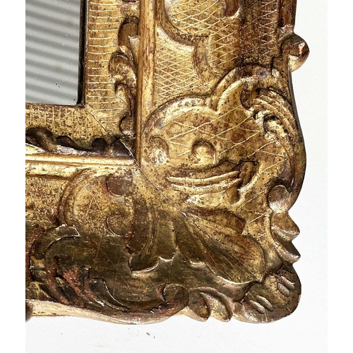 251 - WALL MIRROR, early 19th century Italian carved giltwood grotto style arched with foliate crest, 76cm... 