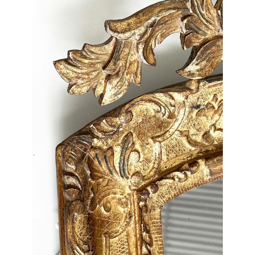 251 - WALL MIRROR, early 19th century Italian carved giltwood grotto style arched with foliate crest, 76cm... 