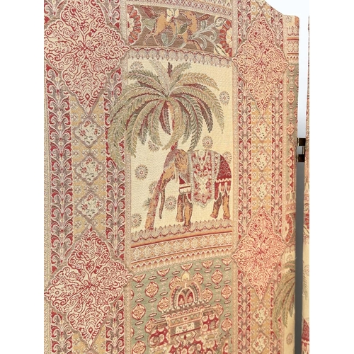 263 - SCREEN, three fold arched 'Raj' fabric, upholstered with elephants and palm trees and brass studded,... 