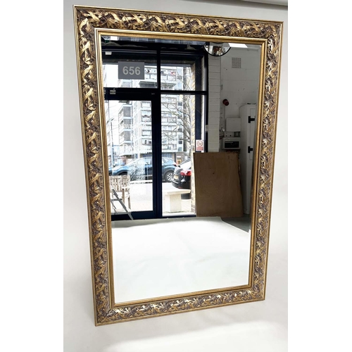 266 - WALL MIRROR, rectangular gilt composition with pierced foliate frame, 176cm H x 114cm.