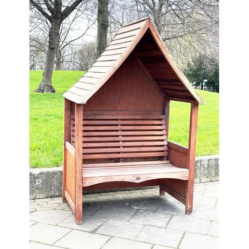 396 - ARBOUR SEAT, traditional form well weathered wood with slatted seat and boarded gable roof, 138cm x ... 