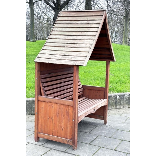 396 - ARBOUR SEAT, traditional form well weathered wood with slatted seat and boarded gable roof, 138cm x ... 