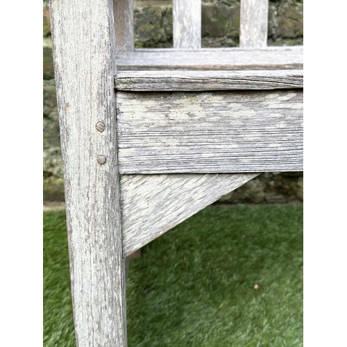 397 - GARDEN BENCH, silvery weathered teak of slatted construction, 130cm W, by 'Lister'.