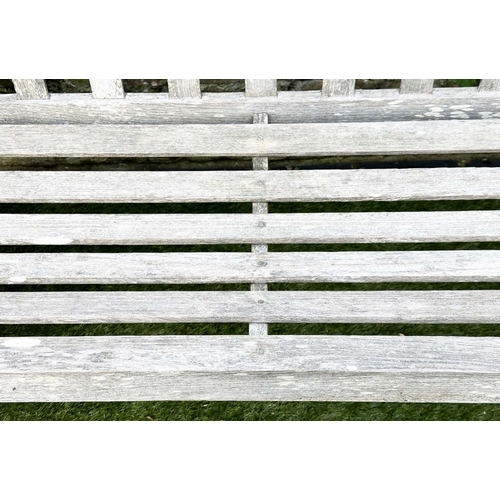 397 - GARDEN BENCH, silvery weathered teak of slatted construction, 130cm W, by 'Lister'.