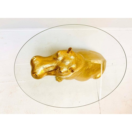 355 - HIPPOPOTAMUS TABLE, glass top gilt resin base, 65cm H x 45cm x 50cm L.