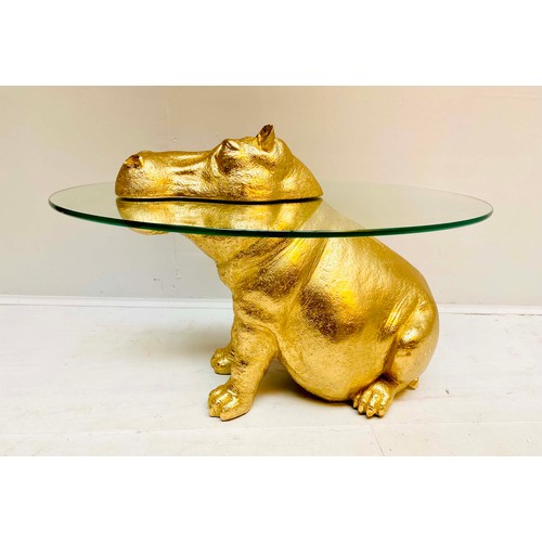 355 - HIPPOPOTAMUS TABLE, glass top gilt resin base, 65cm H x 45cm x 50cm L.