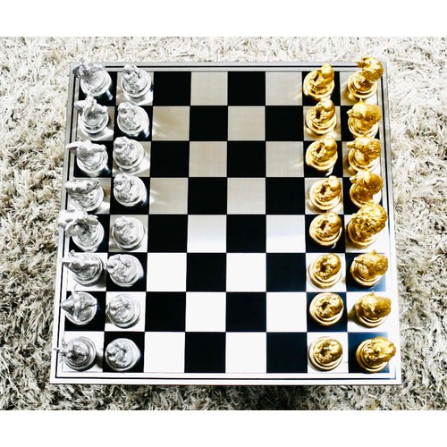 365 - CHESS SET, with gilt and silvered animal pieces, board 60cm x 60cm.