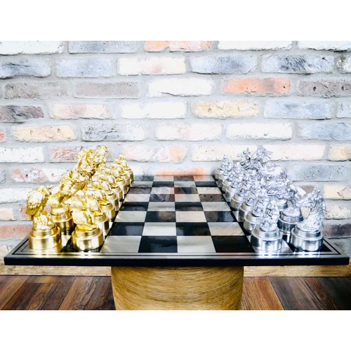 365 - CHESS SET, with gilt and silvered animal pieces, board 60cm x 60cm.