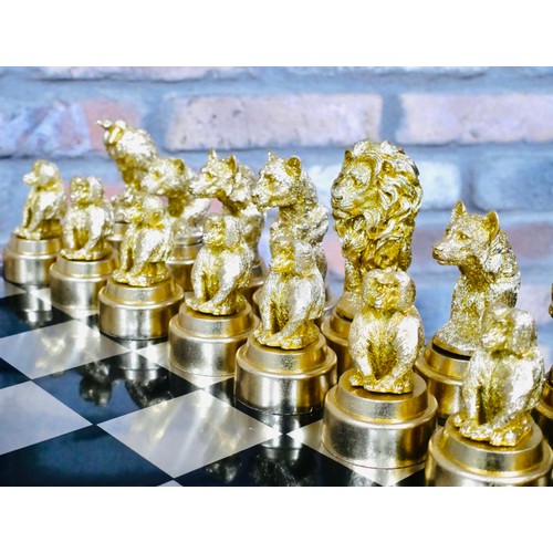 365 - CHESS SET, with gilt and silvered animal pieces, board 60cm x 60cm.