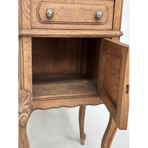 221 - BEDSIDE CABINETS, a pair, 19th century French oak, each with drawer, and panelled door with grey mar... 