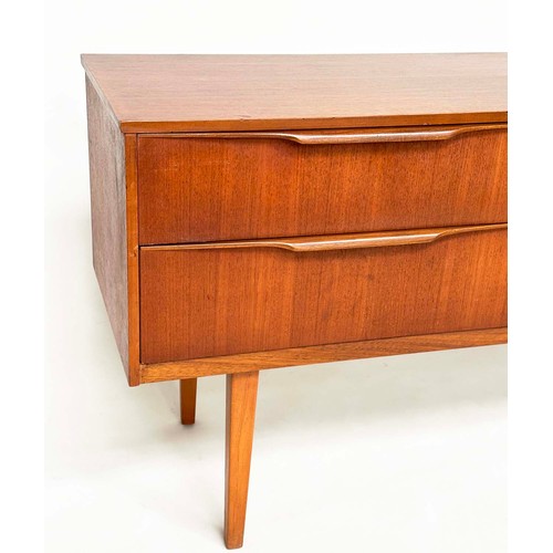 311 - AUSTIN SUITE LOW CHEST, 1970s teak with four drawers, 128cm W x 70cm H x 41cm D.