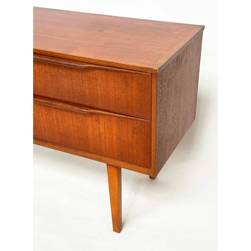 311 - AUSTIN SUITE LOW CHEST, 1970s teak with four drawers, 128cm W x 70cm H x 41cm D.