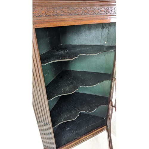 271 - GLAZED CORNER CABINET, George III mahogany with carved blind fretwork detail with fluted detail and ... 