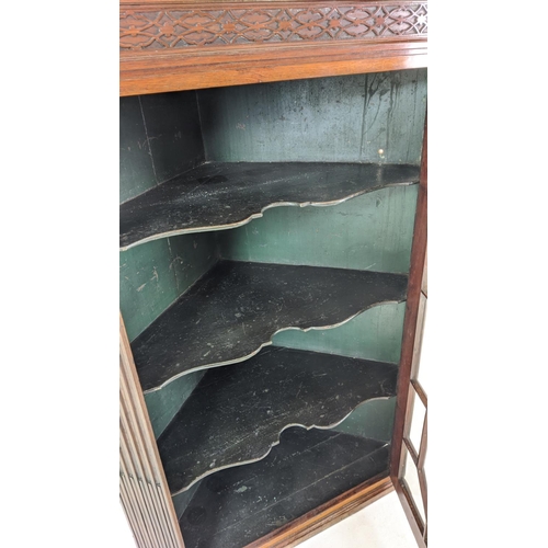 271 - GLAZED CORNER CABINET, George III mahogany with carved blind fretwork detail with fluted detail and ... 