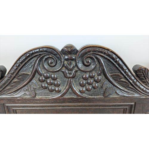 261 - WAINSCOT ARMCHAIRS, a pair, late 19th century Carolean style oak with carved backs, 119cm H x 61cm x... 