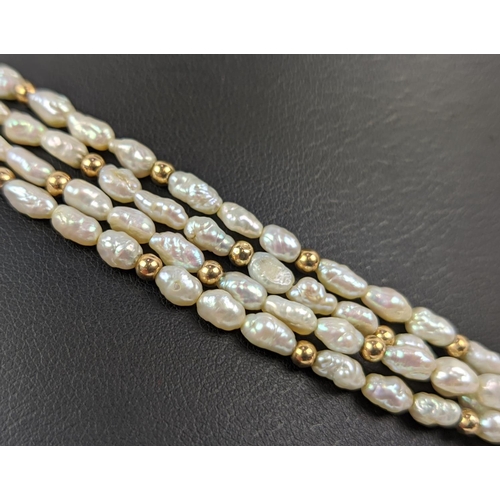 18 - A FOUR STRAND RICE PEARL NECKLACE, with a gold ball clasp, a 9ct gold gatelink bracelet, etc