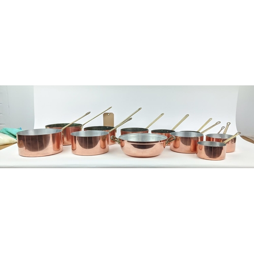 241 - BATTERIE DE CUISINE, a graduated set of twelve, copper pans, with brass handles. (12)