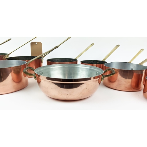 241 - BATTERIE DE CUISINE, a graduated set of twelve, copper pans, with brass handles. (12)
