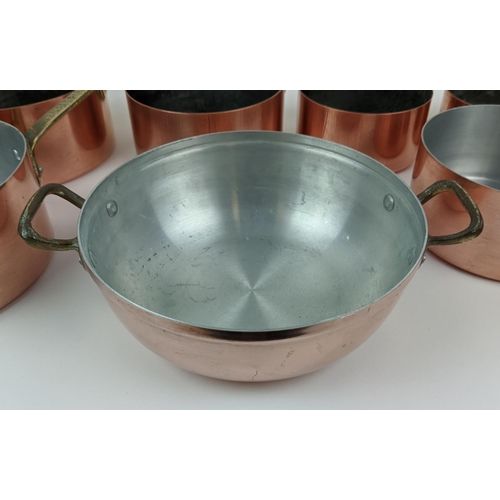 241 - BATTERIE DE CUISINE, a graduated set of twelve, copper pans, with brass handles. (12)