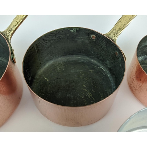 241 - BATTERIE DE CUISINE, a graduated set of twelve, copper pans, with brass handles. (12)